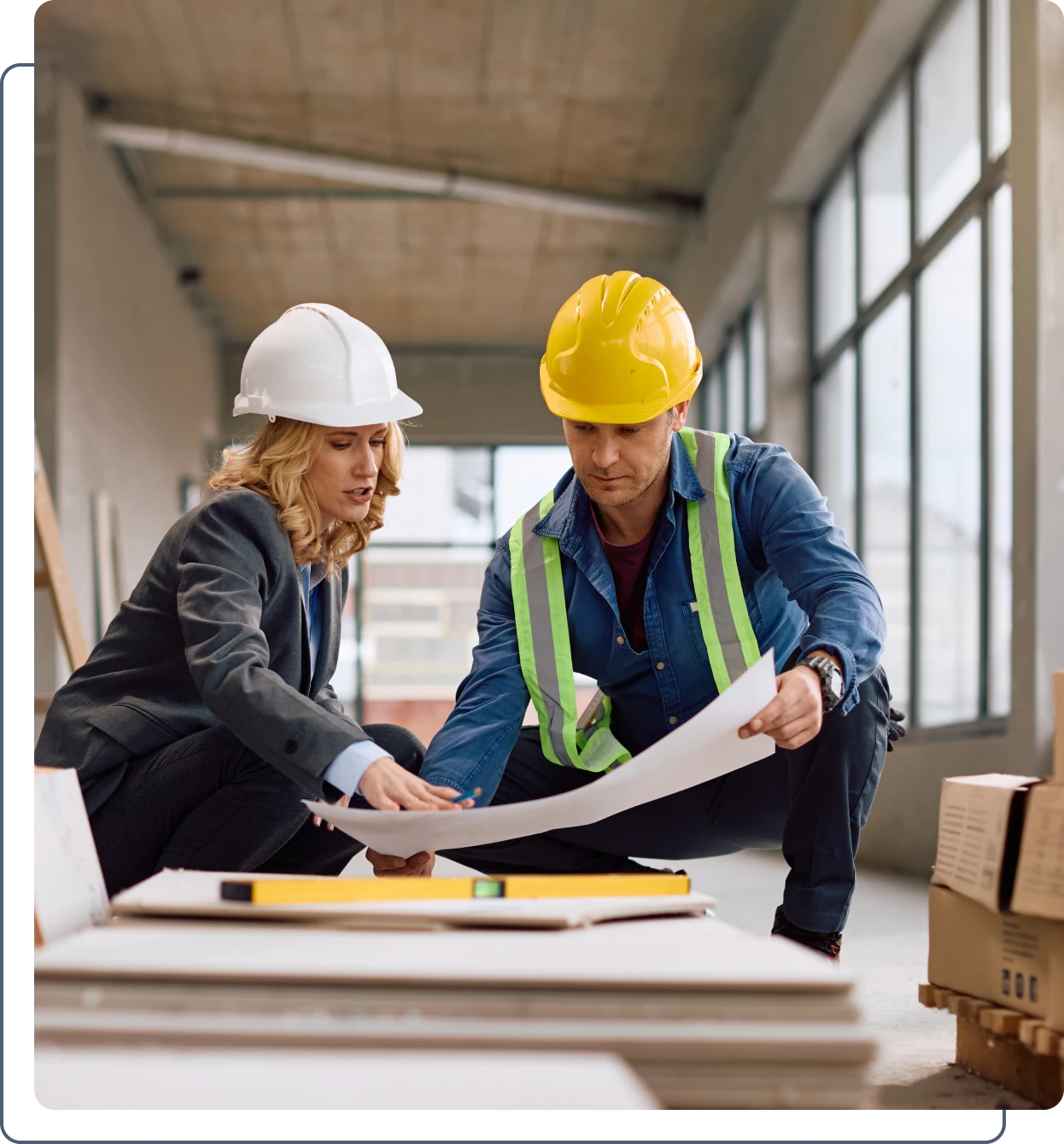 Architects reviewing construction plans on site