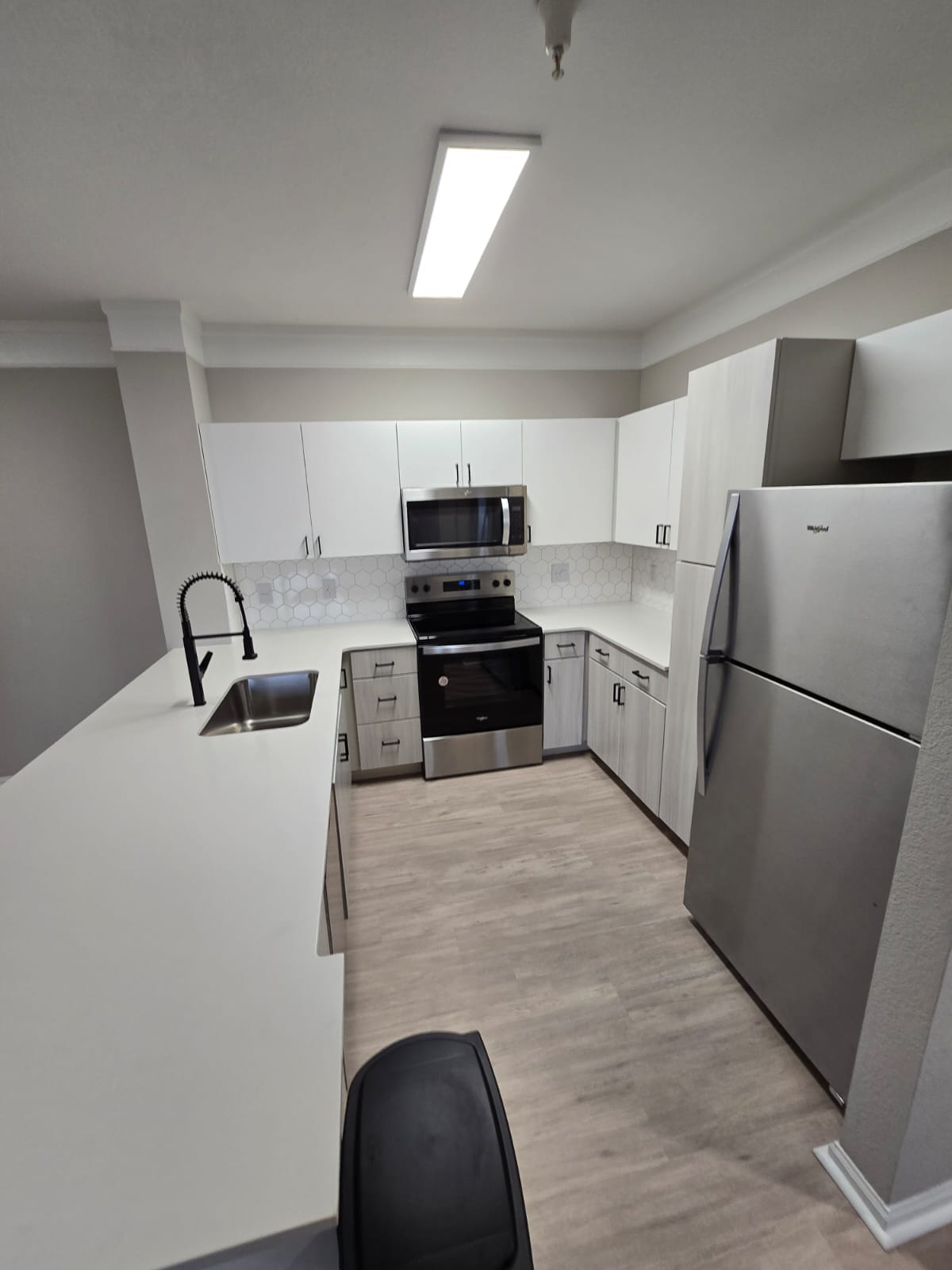 Contemporary kitchen with light wood flooring