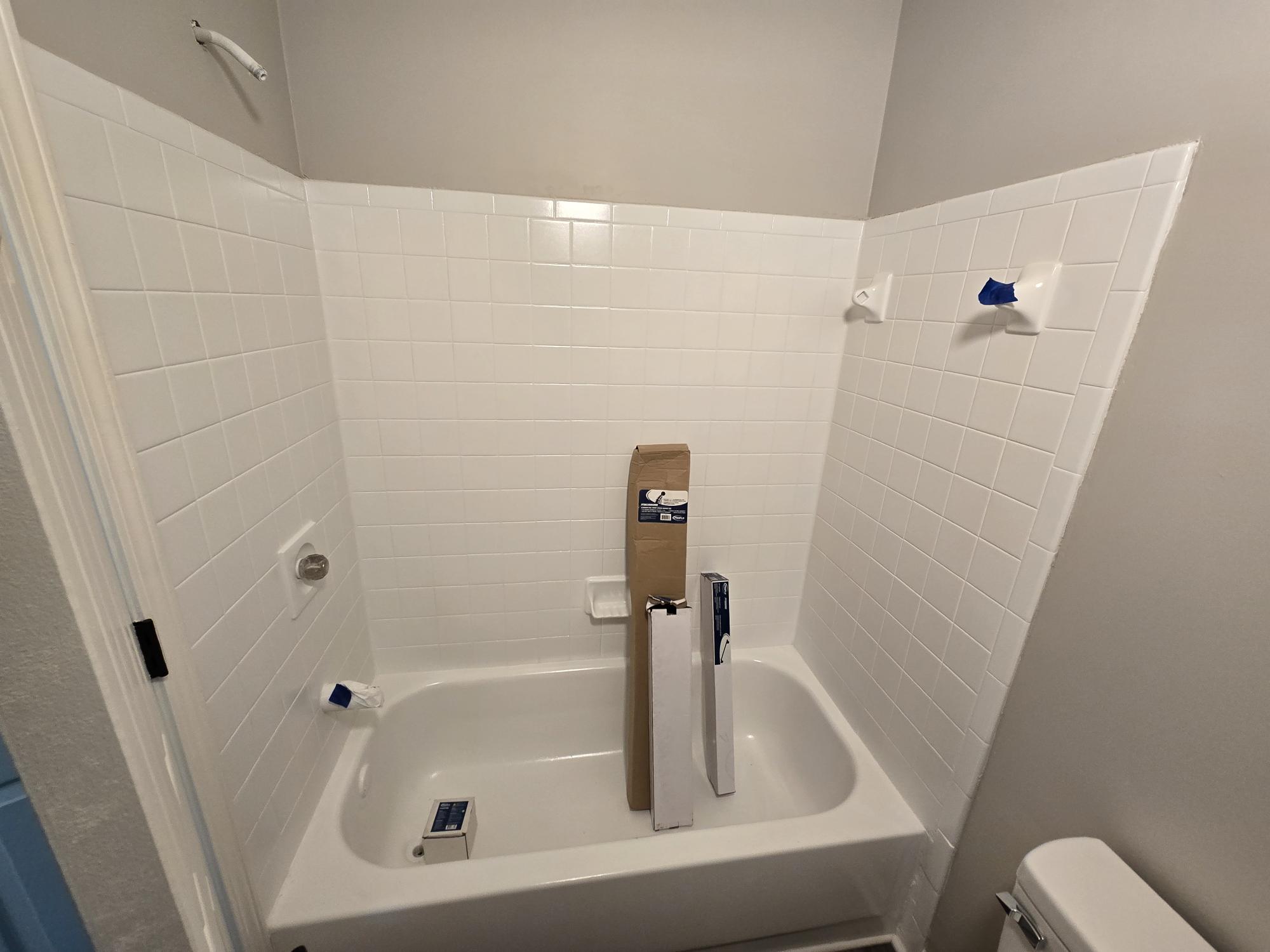 Bathroom renovation with white tiles and tub