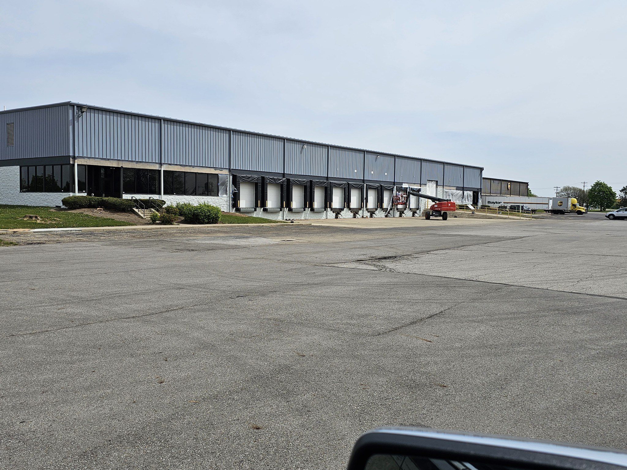 Empty parking lot in front of warehouse